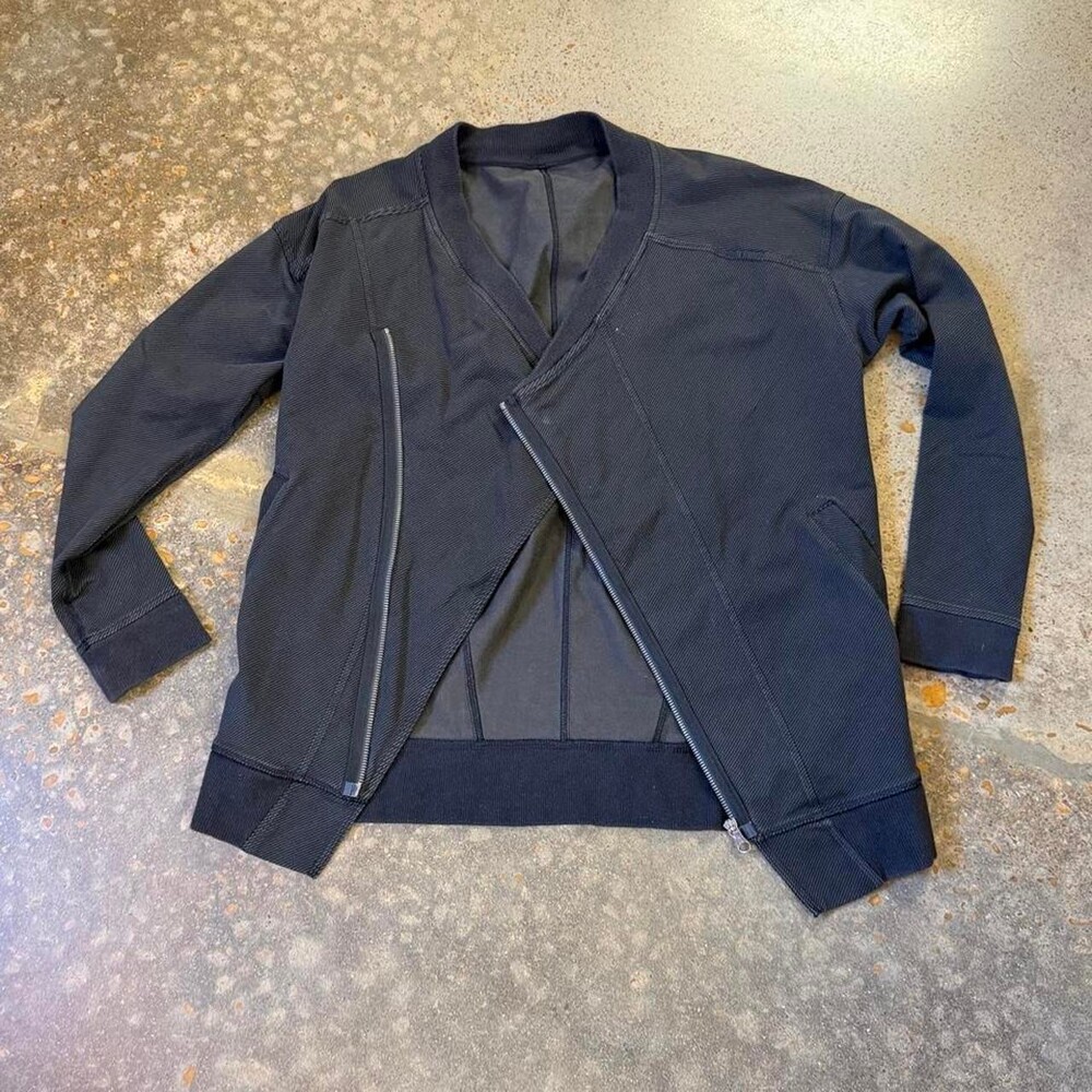 Lululemon black asymmetrical zip jacket. Size tag is missing; estimated Women’s